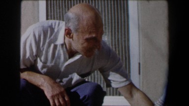 1958: elder man preoccupied with something in the corner. CALIFORNIA