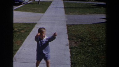 1958: a little lad walking along the concrete pavement in the meadow LAS VEGAS
