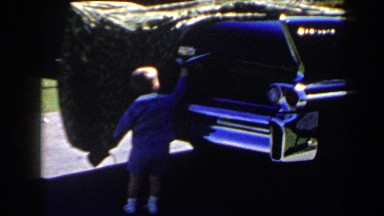 1958: little boy checking out a car. LAS VEGAS
