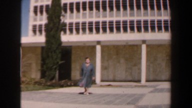 1960: A Working Woman Wearing a Jacket Leaves for Home from Her Job