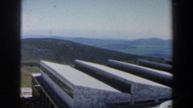 1960: a view of vistas and mountains from vehicle, with houses and neighborhoods