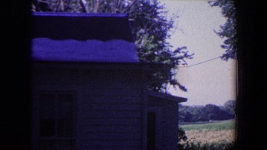 1959: standing outside a country house in the winter and examining the roofing.
