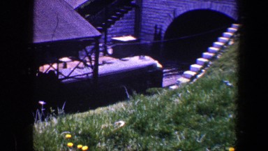 1960: freight train goes under roofed structure and enters tunnel below overpass