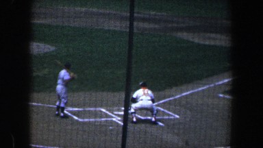 1960: group of baseball players warming up for the big game by practicing.