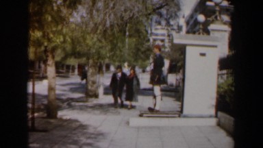 1960: Couple Walking Hand in Hand Down Path Wearing Coats in Israel