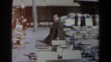 1960: Woman on Patio Area of Sidewalk Walking Toward Camera