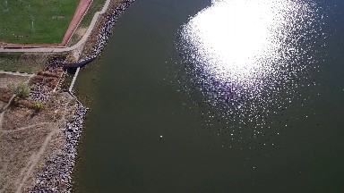 aerial footage of a jetty lined with rocks next to a golf course COLORADO