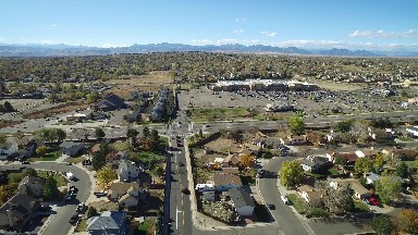 bird's eye view of a neighborhood with a parking lot and cars COLORADO
