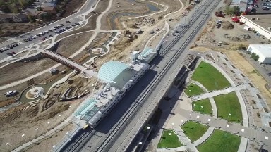 an aerial view of an urban railroad station as a train departs COLORADO