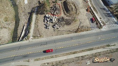 Colorado, United States: Red Car Driving Through Barren City Under Construction
