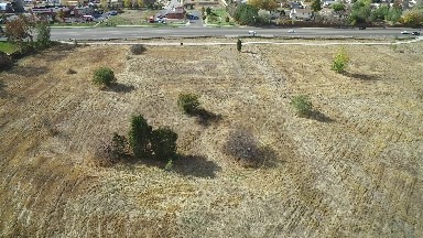 an aerial view of a field in a neighborhood next to a roadway COLORADO