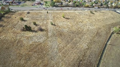 airplane viewing of a field with a highway off to the side. COLORADO