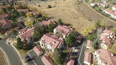 a field next to the rich part of town, seen from above at daytime COLORADO