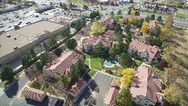 a sweeping shot of a city, including a park, a neighborhood