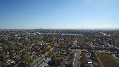 the view flying over the top of a town that has a body of water COLORADO