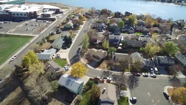 COLORADO, United States: an aerial view of a suburban cluster of homes next to a body of water and a