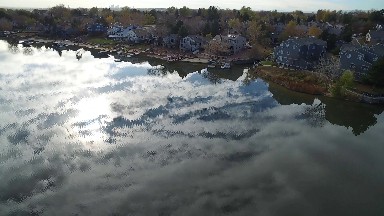 aerial view of landscape with a shiny lake and houses on the shore COLORADO