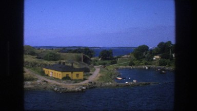 1975: A House Next to a Clear Blue Lake at Daytime, Seen from Above, Sweden
