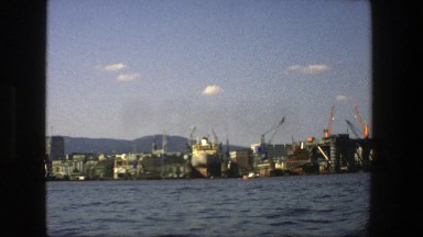 1975: an area by the water that has a cranes with the arm in the air STOCKHOLM
