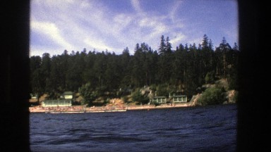 1975: drive by of a beautiful lake. STOCKHOLM SWEDEN