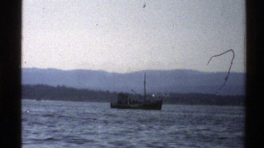 1976: A Boat Moving Through the Blue Waters of the Sea Norway