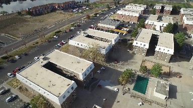 site contains buildings, lots and cars placed in orderly geometric arrangements