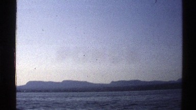 1976: Hills Lining the Shoreline in a Moving Vehicle, Norway
