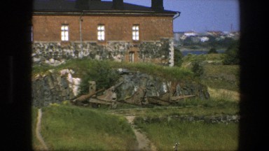 1975: A Rustic Old Brick and Stone Building atop a Green Hill Sweden