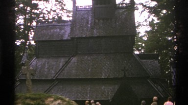 1976: Walking Amongst a Group of People to View a Large Monument and Church