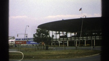 1976: shot of the outside of a stadium with a circular roof and a pan american