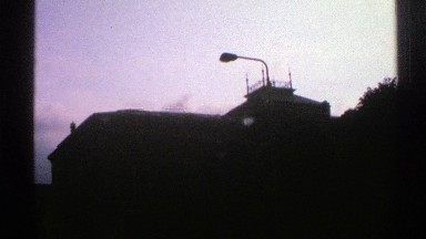 1976: silhouetted building with large top light on a hilly area NORWAY