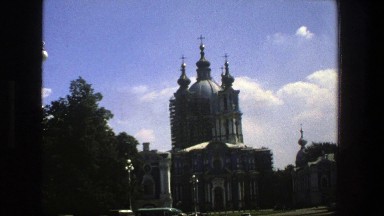 1975: structure in a city with vehicles around and ornate decorations
