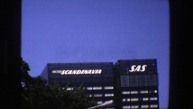 1975: lighted sign on the top of a tall building. STOCKHOLM