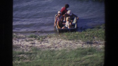 1971: Group of People in a Body of Water Riding in an Enclosed Vessel