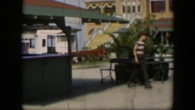 1951: a young boy in a striped shirt walking outdoors through a courtyard UTAH