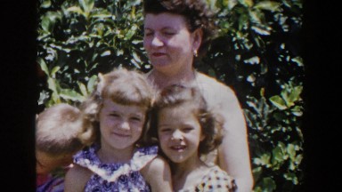 1953: A Mother Sitting Outdoors with Three Children in Lubbock Texas