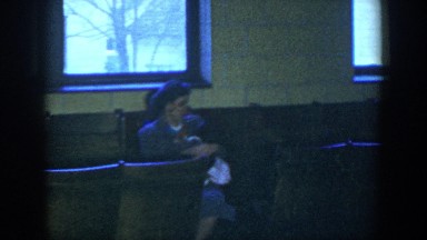 1952: mother rocking her toddler in church. HOUSTON TEXAS