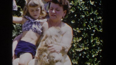 1953: woman and child petting a dog. LUBBOCK TEXAS