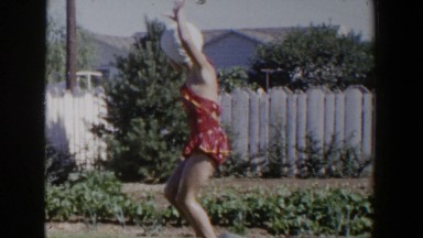 1953: child dancing around outside in bathing suit before going into the pool