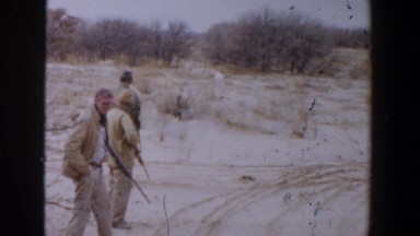 1956: men wearing hats and holding guns in a desert field LUBBOCK TEXAS