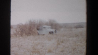 1956: A Truck Moving with Two People Sitting in the Open Back Lubbock Texas