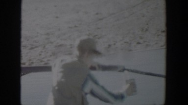 1957: parched boy quenches his thirst with a tin can and water