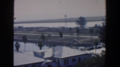 1951: View of a Small Cuban Community with Homes and Cars Driving By
