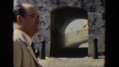1951: man walking toward a stone building. CUBA
