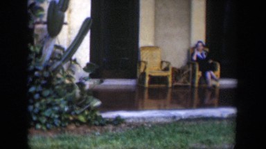1951: Woman Sitting on Porch of Colonial Building in Cuba