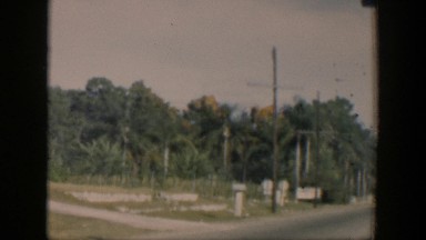 1951: car casually driving down the street. CUBA