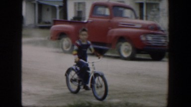 1951: Cute Little Boy Riding a Bike in Cuba