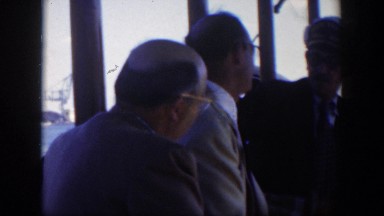 1951: three men engaged in a serious conversation inside a restaurant CUBA