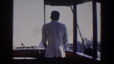 1951: a man sailing on the sea and watching the magnificent view on a windy day