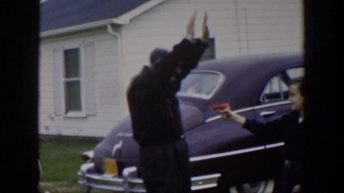 1951: the old father is at the gunpoint of his son with a red revolver CUBA